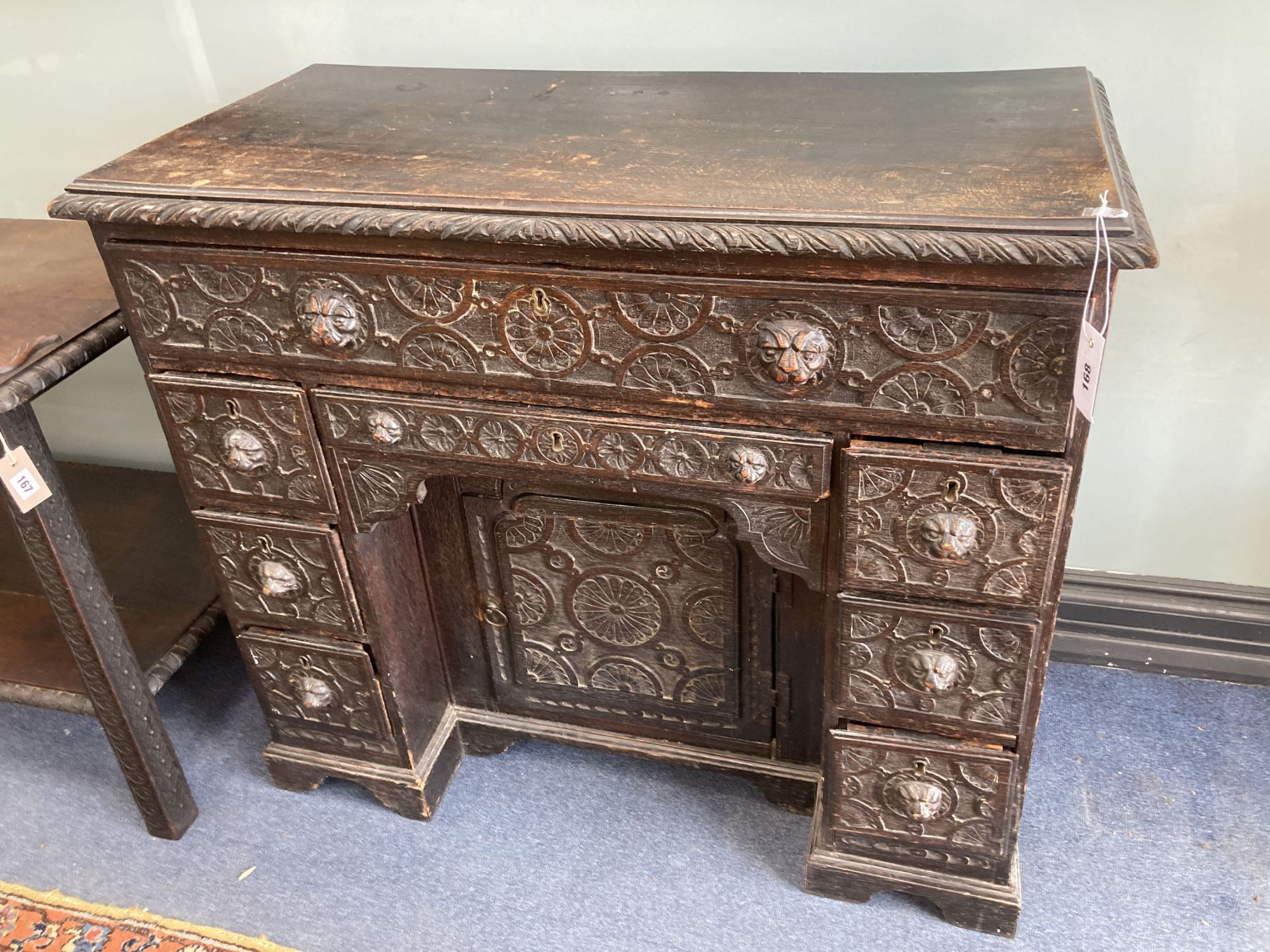 A late 19th century carved oak kneehole desk, length 94cm, depth 48cm, height 82cm